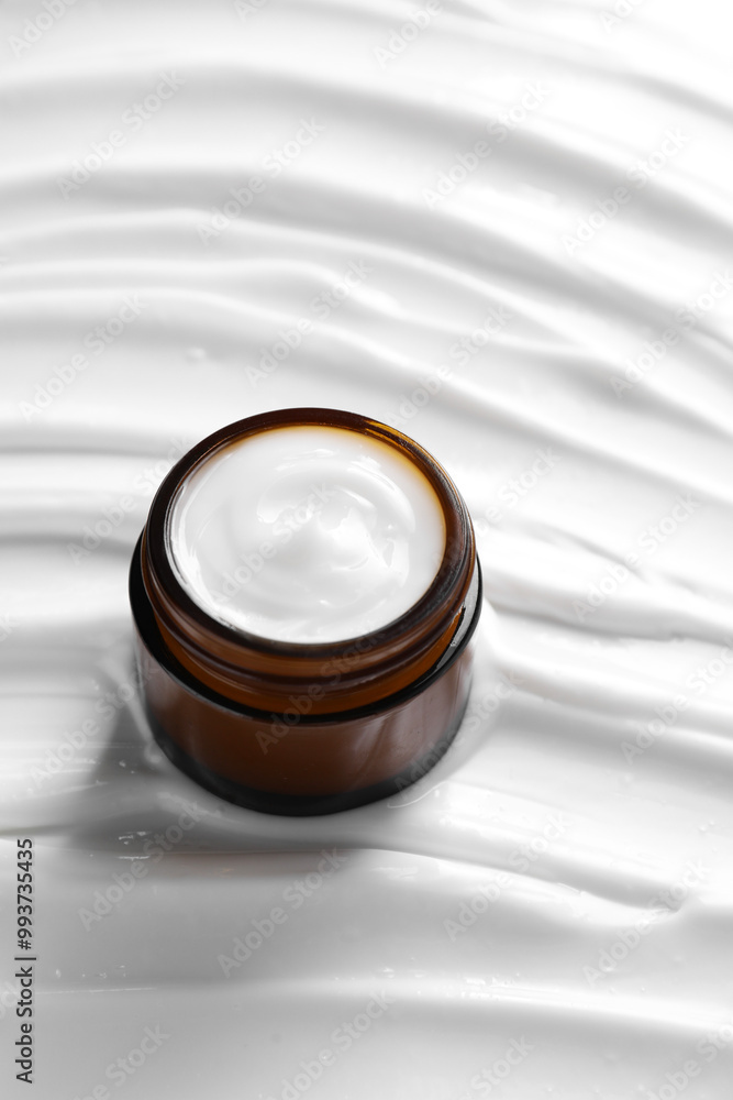 Face cream in jar on cosmetic product, closeup Face cream in jar on cosmetic product, closeup