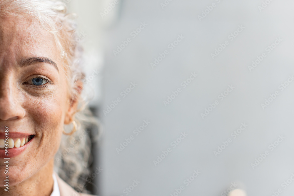 Smiling woman with freckles and hoop earring, close-up portrait with focus on face, copy space Smiling woman with freckles and hoop earring, close-up portrait with focus on face, copy space