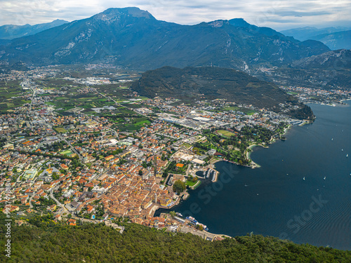 Picturesque town of Riva del Garda by Lake Garda, surrounded by mountains and crystal-clear water. Aerial view photo