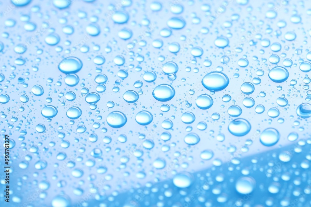 Water drops on light blue background, closeup Water drops on light blue background, closeup