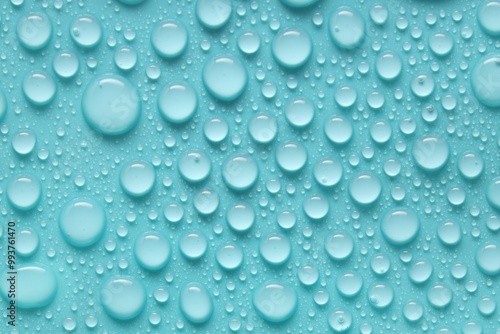 Water drops on turquoise background, above view