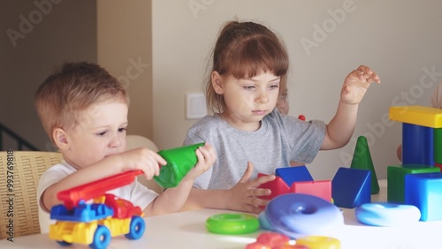 kindergarten. a group of children play toys cubes and cars on the table in kindergarten. kid dream creative happy family preschool education concept. nursery baby toddler indoor home