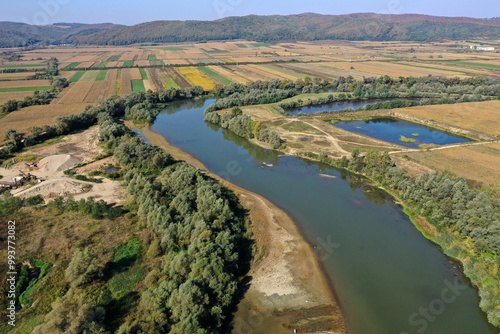 Aerial view of gravel pit mining reservoir and river, ballast, ecological impact on environment