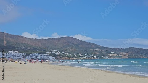 Tetouan, Morocco - 20 August 2024, view of people swimming and enjoying vacation in Cabo Negro, also known as Cabo Negro Beach and Golf Resort is a beach resort in northern Morocco  photo