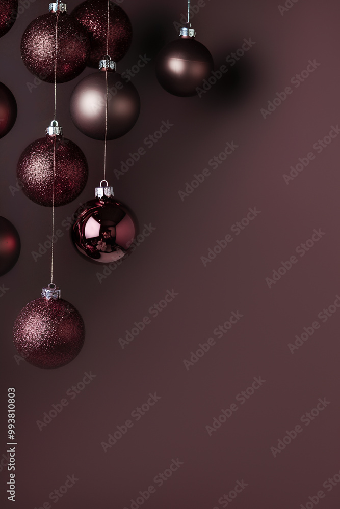 Christmas vertical background. Bronze and chocolate Christmas ornaments on a dark brown background with copy space. Christmas vertical background. Bronze and chocolate Christmas ornaments on a dark brown background with copy space.