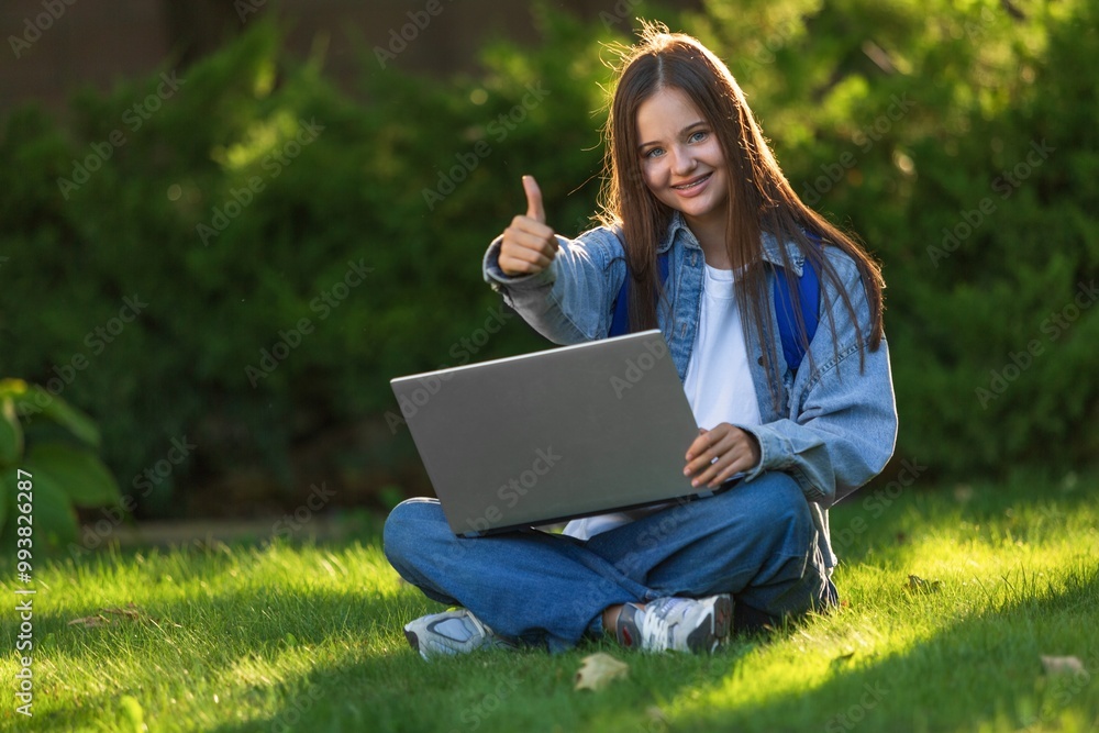 Young happy girl student with laptop computer outdoors. Young happy girl student with laptop computer outdoors.