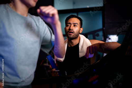 Asian man and woman working out, one is a trainer, the other is an exerciser