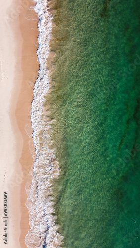 Aerial view of the beautiful turquoise sea with algae in Comporta, Portugal