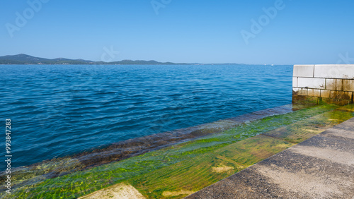 Sea Organ playing music through waves and pipes under marble steps in Zadar, Croatia.