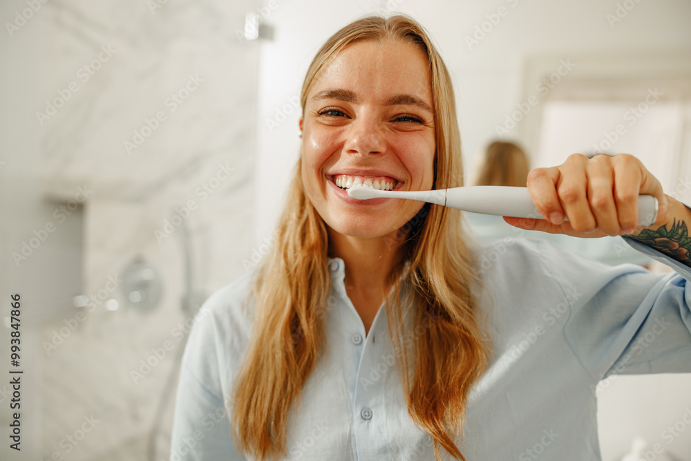 A cheerful and joyful woman happily brushing her teeth, demonstrating a healthy and positive morning routine A cheerful and joyful woman happily brushing her teeth, demonstrating a healthy and positive morning routine