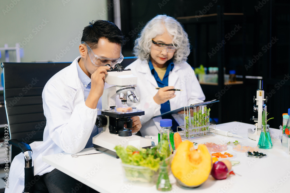Food scientists in lab coats, testing samples, and analyzing food safety and quality in a modern laboratory Food scientists in lab coats, testing samples, and analyzing food safety and quality in a modern laboratory