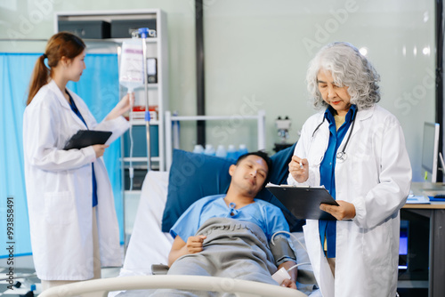 Hospital Ward Male and Male Professional Asian Doctors Talk with a Patient, Give Health Care Advice,