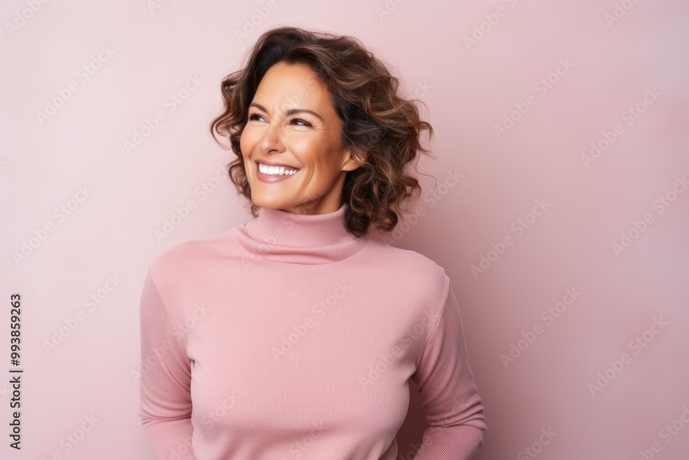 Portrait of a satisfied woman in her 40s wearing a thermal fleece pullover isolated on pastel or soft colors background Portrait of a satisfied woman in her 40s wearing a thermal fleece pullover isolated on pastel or soft colors background
