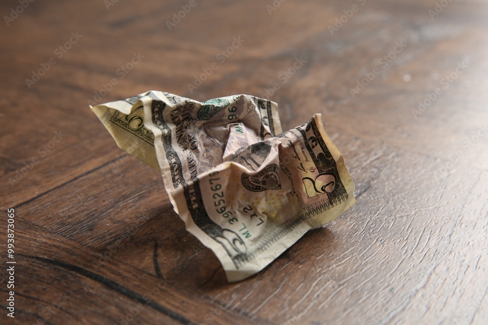 One crumpled dollar banknote on wooden table, closeup One crumpled dollar banknote on wooden table, closeup