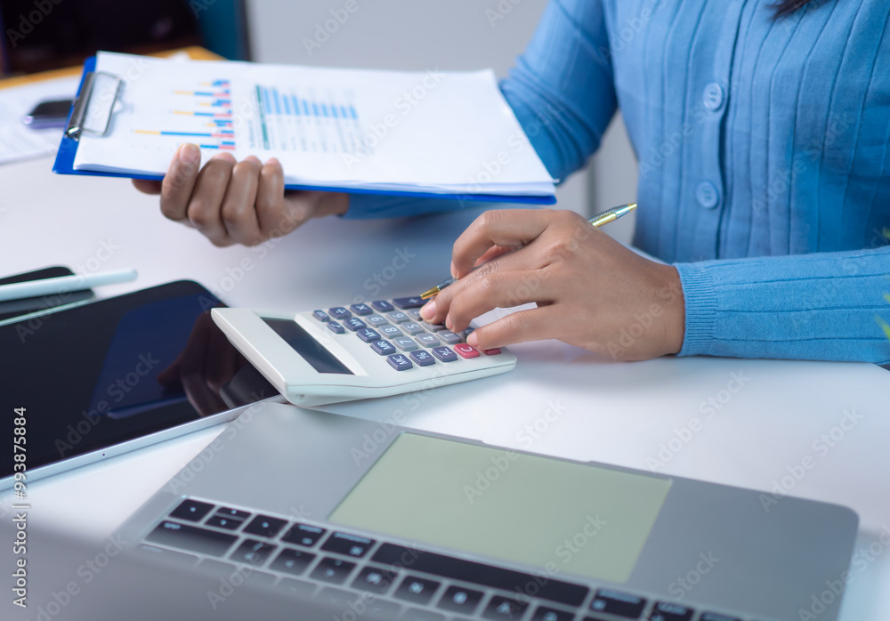 Businesswoman hand working with finances about cost and calculator and laptop with tablet on desk at office in morning light, Business accounting concept, Calculating or checking balance. Businesswoman hand working with finances about cost and calculator and laptop with tablet on desk at office in morning light, Business accounting concept, Calculating or checking balance.