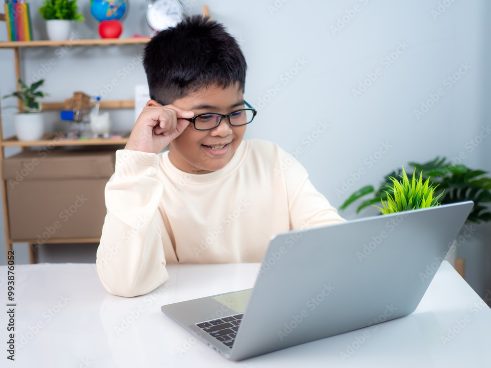 Asian boy student using computer laptop learning. Educational of tech concept, Staying at home, Presenting a modern educational way of life. Virtual internet online class from school teacher. Asian boy student using computer laptop learning. Educational of tech concept, Staying at home, Presenting a modern educational way of life. Virtual internet online class from school teacher.