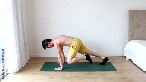 homem fazendo exercicios fisícos em casa  photo