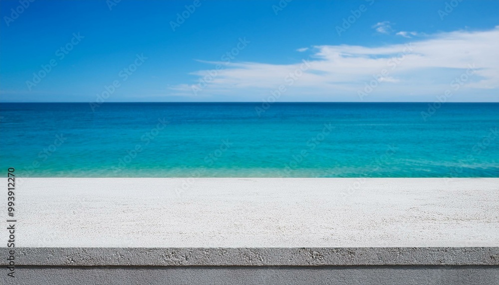 Fototapeta premium Concrete table top against the background of the sea on the beach. Empty white countertop for product presentation with blue water and sky. Outdoor mockup