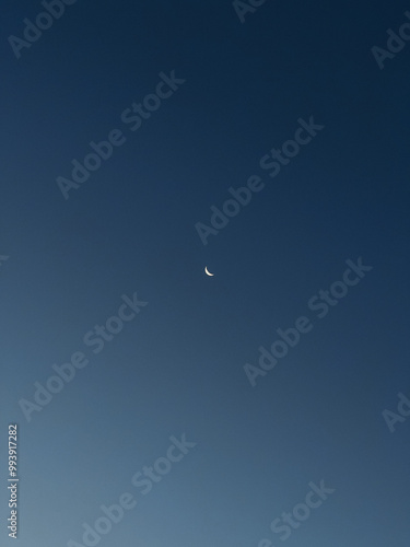 Early night sky with a small crescent moon