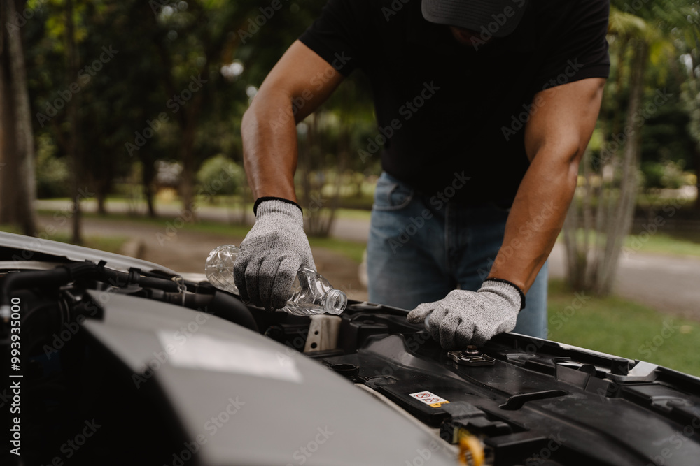 Mechanic Repairing Car Engine: Close-up shot of a man's hands meticulously working on a car engine, showcasing focus and expertise in auto repair. Mechanic Repairing Car Engine: Close-up shot of a man's hands meticulously working on a car engine, showcasing focus and expertise in auto repair.