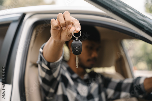 New Car Keys: A man's hand proudly displays car keys, signifying a new beginning, freedom, and personal achievement. 