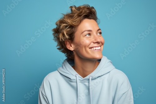 Portrait of a satisfied woman in her 30s wearing a zip-up fleece hoodie isolated on solid color backdrop