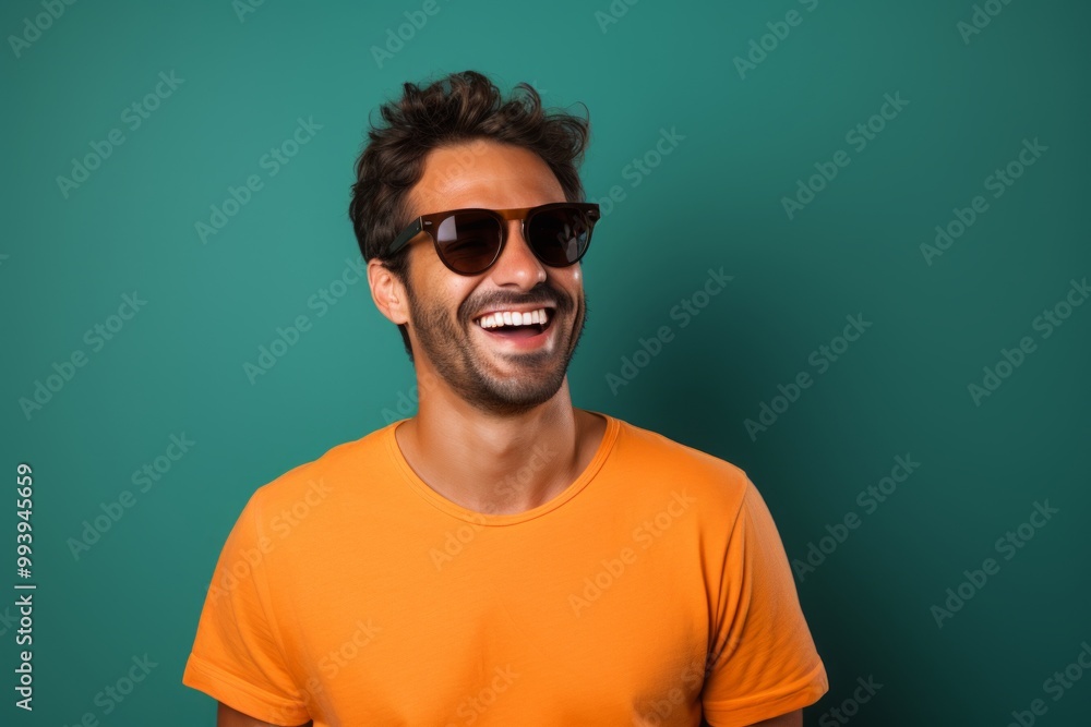 Portrait of a smiling man in his 30s wearing a trendy sunglasses on solid color backdrop