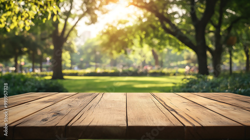 blank wooden table on green summer park background banner 