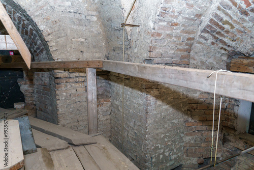 The vaulted ceilings in the old red brick building. An old dusty corridor in the dungeon. The study of antediluvian buildings and structures. photo