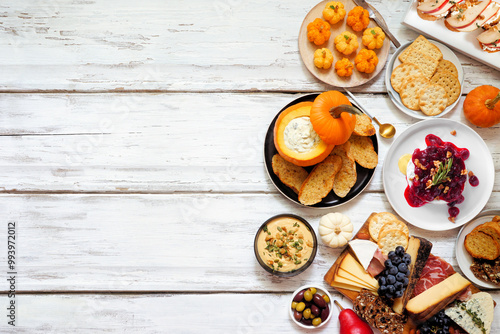 Wallpaper Mural Fall theme appetizer side border against a white wood background. Charcuterie board, pumpkin and apple dips, crostini, cheeses and snacks. Top view. Torontodigital.ca