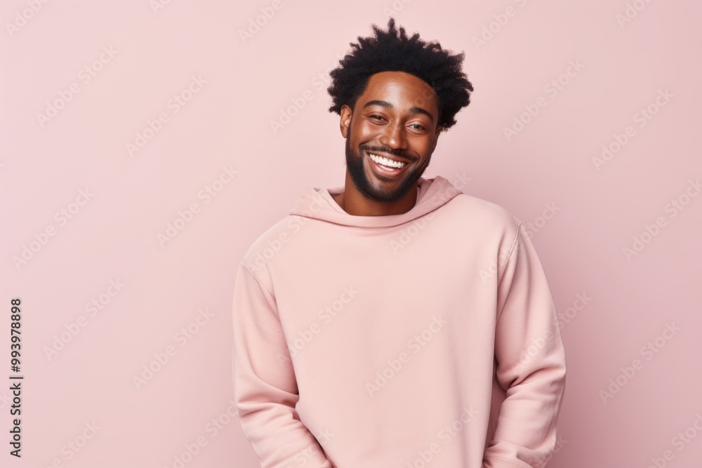 Portrait of a cheerful afro-american man in his 30s dressed in a comfy fleece pullover over solid pastel color wall Portrait of a cheerful afro-american man in his 30s dressed in a comfy fleece pullover over solid pastel color wall