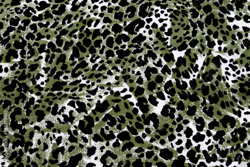 Green, white and black spotted fabric flat lay pattern photo