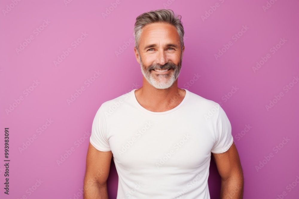 Portrait of a happy man in his 40s donning a trendy cropped top isolated on solid pastel color wall Portrait of a happy man in his 40s donning a trendy cropped top isolated on solid pastel color wall