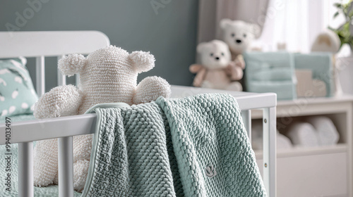 A cozy nursery scene featuring a teddy bear on a crib draped with a soft mint blanket, surrounded by plush toys and pastel décor.