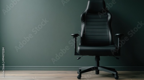 A stylish black ergonomic office chair situated against a dark green wall, showcasing a blend of comfort and sleek, modern design, perfect for professional spaces. photo