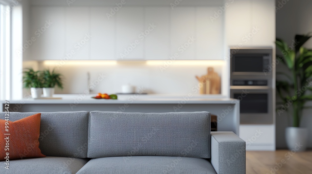 Fototapeta premium Cozy living room featuring a modern sofa, bright kitchen, and inviting atmosphere, perfect for home decor inspiration.