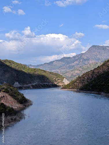 river flowing between majestic mountains and hills