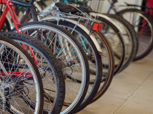 Many bicycles parked in a row taking a break from cycling