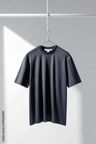 A black t shirt is hanging on a hanger with the word on it ai generated