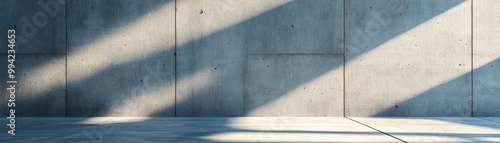 The minimalist concrete wall features subtle texture and shadow play, adding a touch of industrial design to the sleek and modern background.