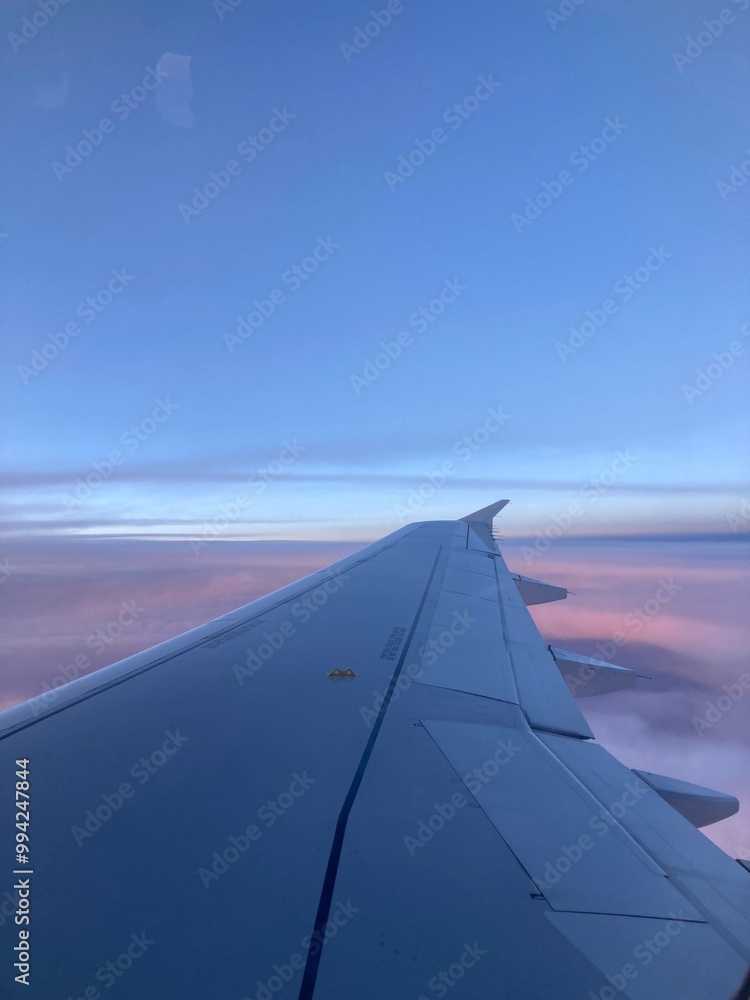 Wing of an airplane above the clouds Wing of an airplane above the clouds