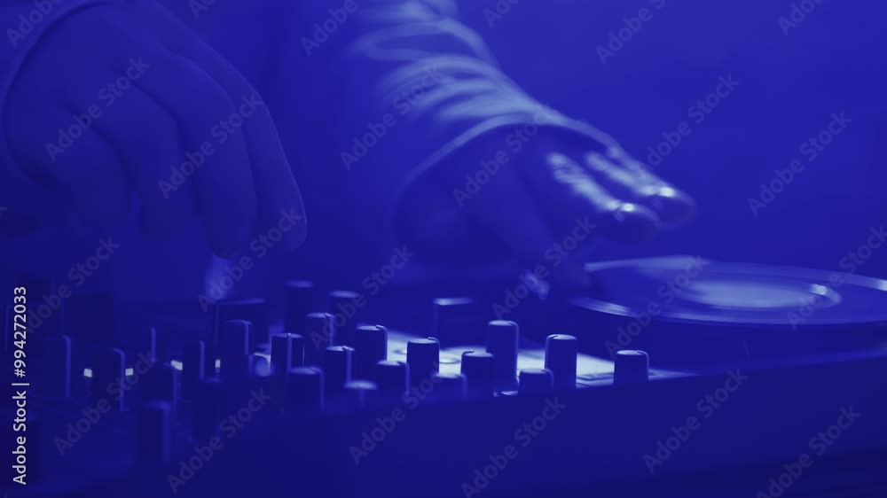 DJ playing music on festival in night club. Techno musician with headphones and sunglasses performing at nightclub for concert crowd of people, city bar. DJ playing music on festival in night club. Techno musician with headphones and sunglasses performing at nightclub for concert crowd of people, city bar.