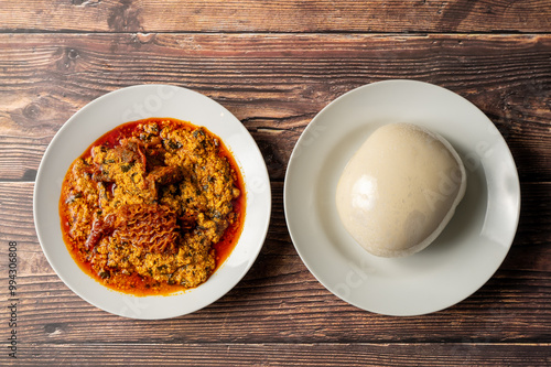 Caption: Tasty Caribbean food served on a white plate or white bowl on a rustic vintage wooden table backdrop - colorful home cooked meals and desserts with chicken, chips, vegetables, rice, bbq, stew