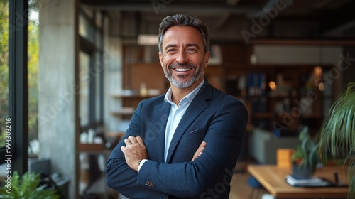 professional businessman standing confidently with a bright smile, arms crossed in a modern office, emphasizing leadership, success, and motivation in the workplace