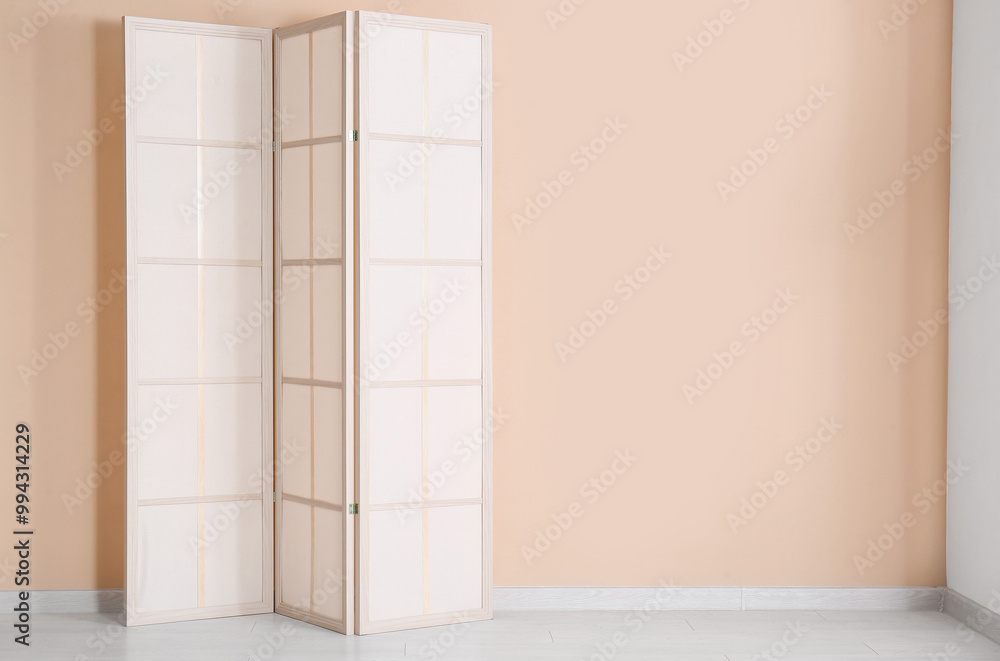 Folding screen near beige wall Folding screen near beige wall