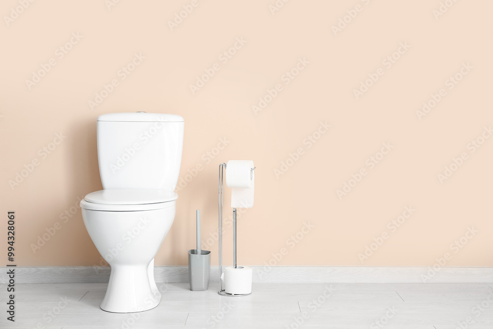 Holder with rolls of paper, ceramic toilet bowl and brush near color wall Holder with rolls of paper, ceramic toilet bowl and brush near color wall