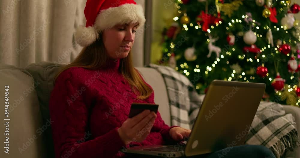Woman Christmas shopping online with laptop Woman Christmas shopping online with laptop