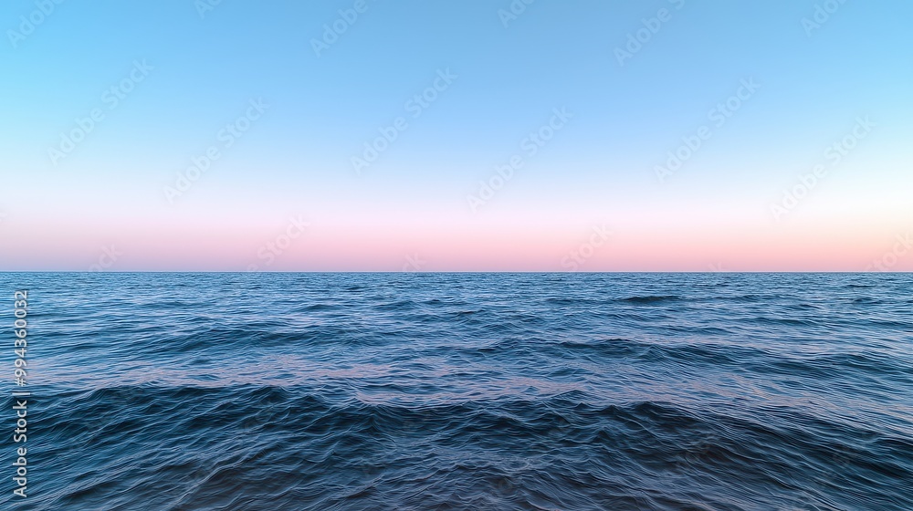 Fototapeta premium The ocean is calm and peaceful, with a beautiful blue sky in the background. The water is still, and the horizon is visible in the distance
