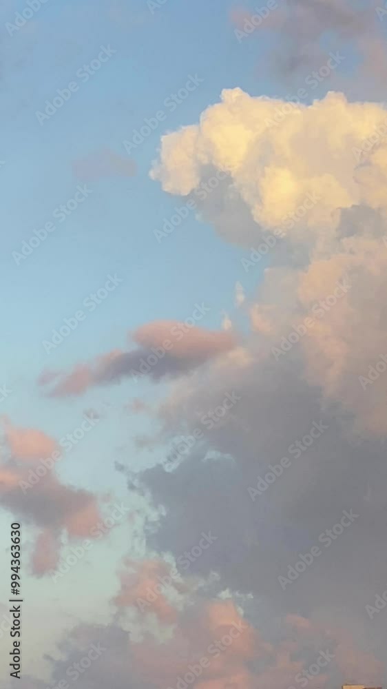 Background. Vertical video. Fast motion pink cumulus clouds in the morning. Mediterranean Sea. Mallorca
