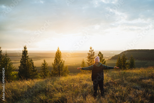 Embracing the Stunning Beauty of Nature A Person Standing Serenely in the Peaceful Midst of a Scenic Landscape Under a Breathtaking Sunset